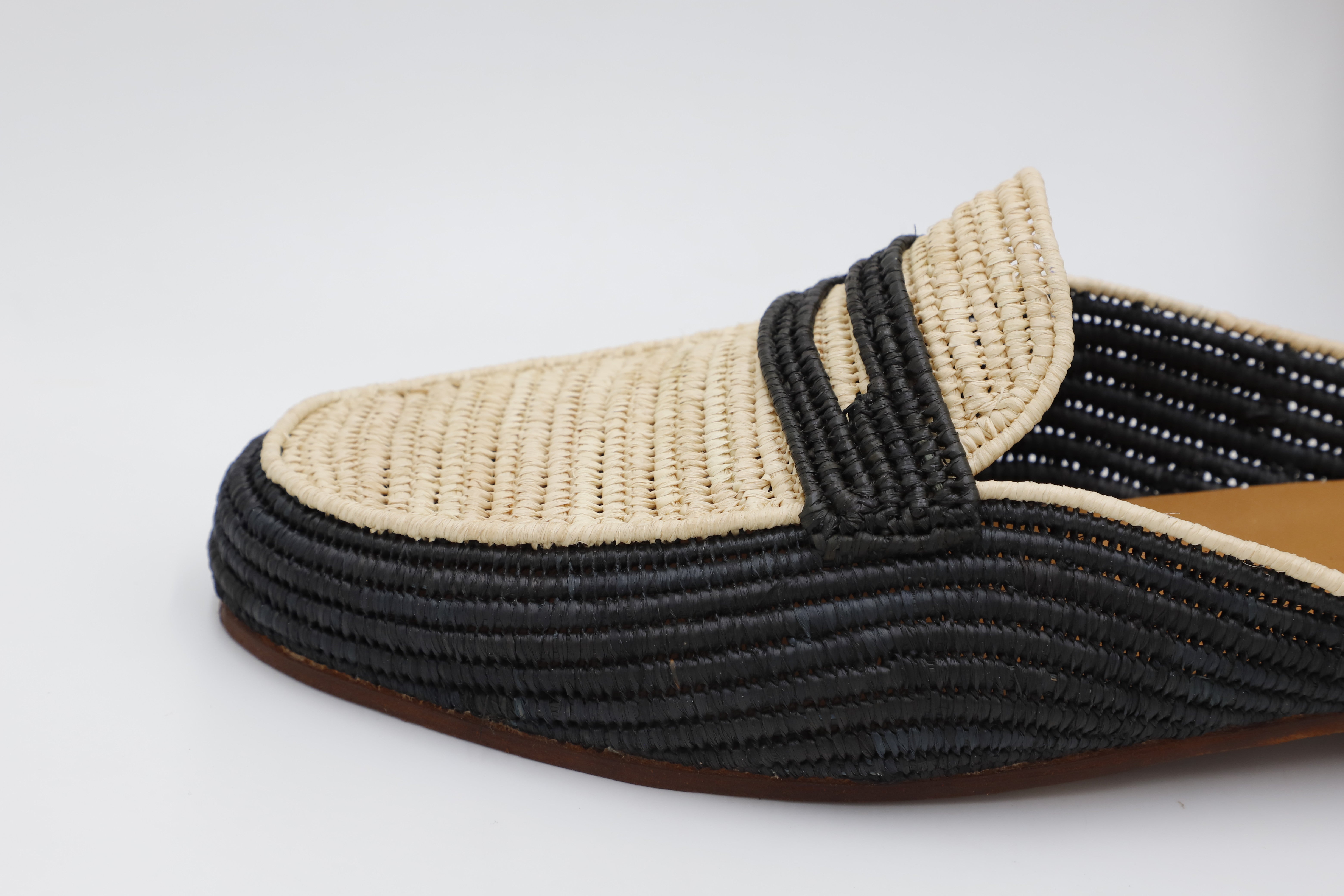 Black and beige woven shoe on a white background