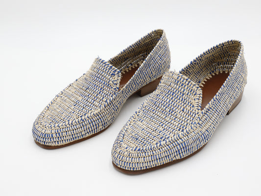 Pair of blue and beige woven loafers on a white background