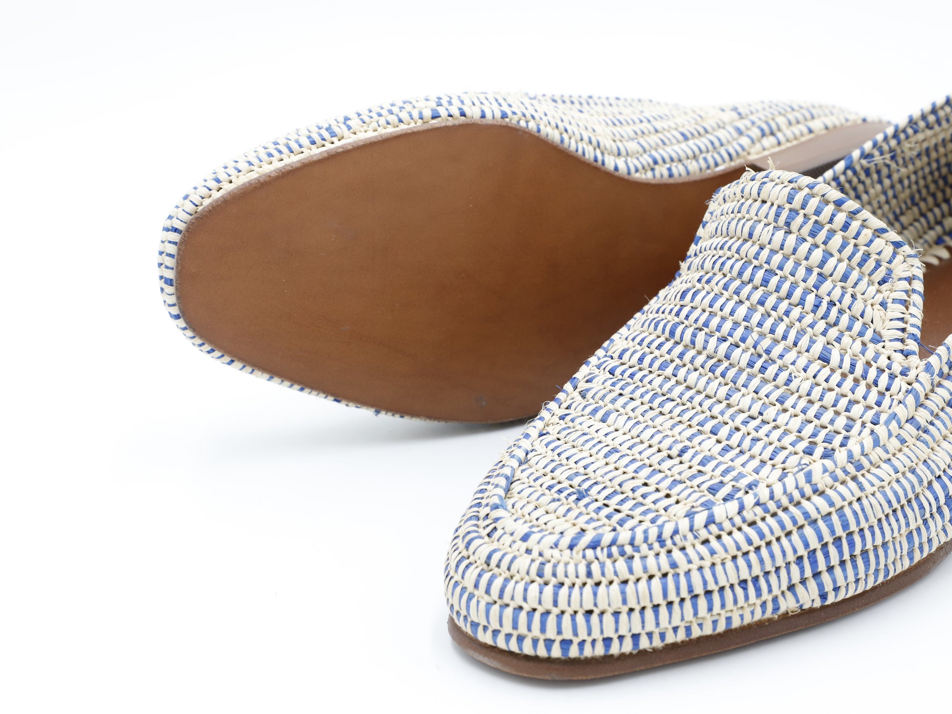 Woven flat shoes with blue and white pattern on a white background
