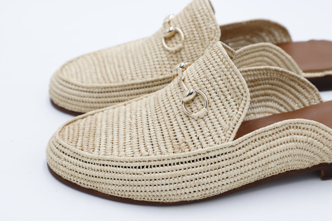Beige woven raffia mules for men on a white background
