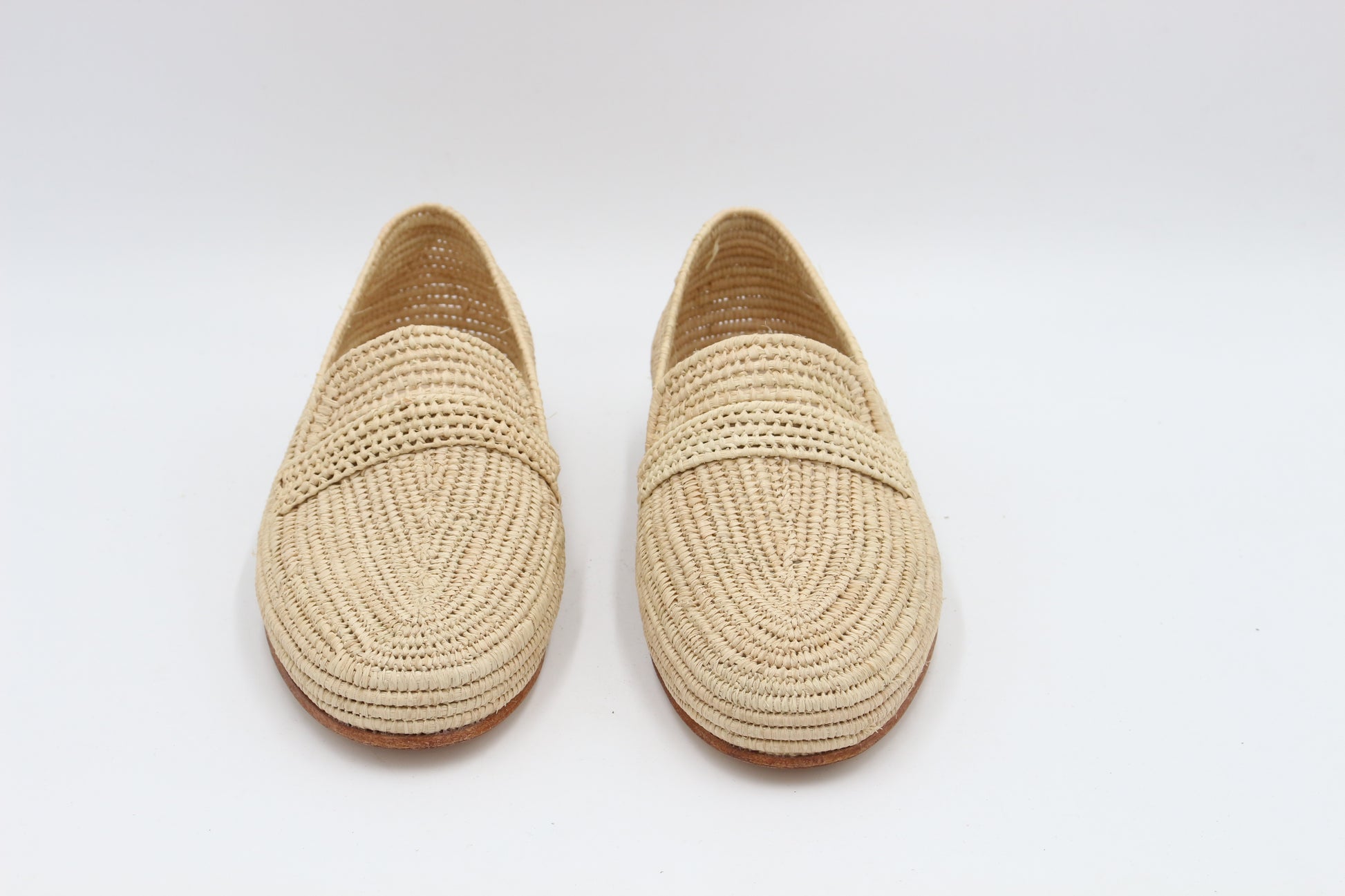 Pair of woven shoes on a white background