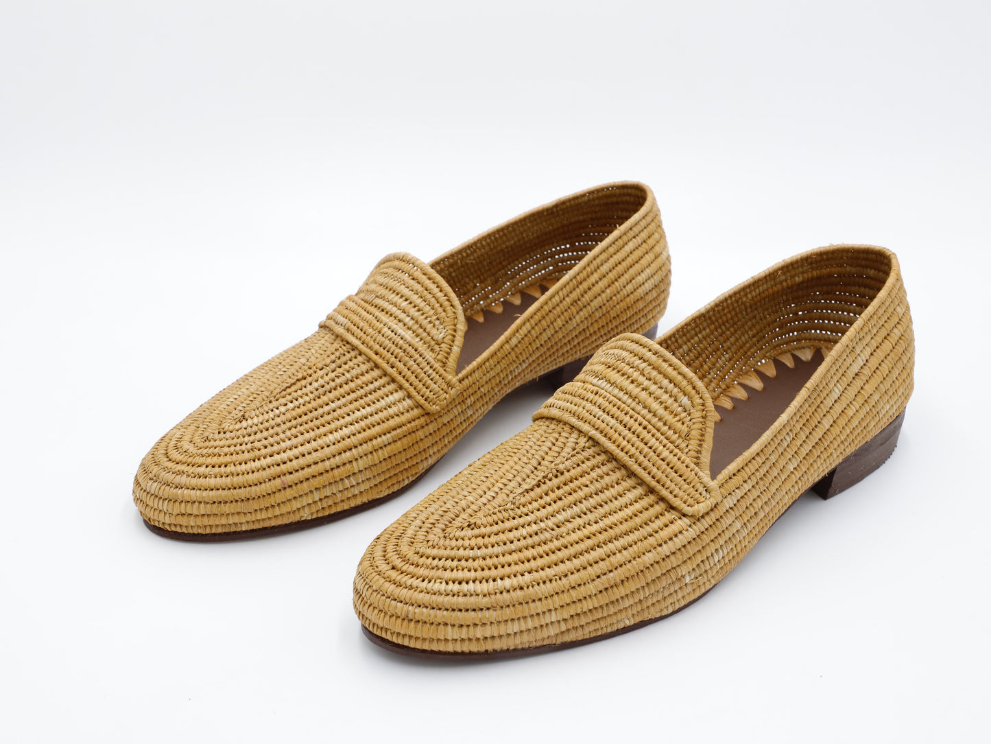 Tan men’s raffia loafers on white background