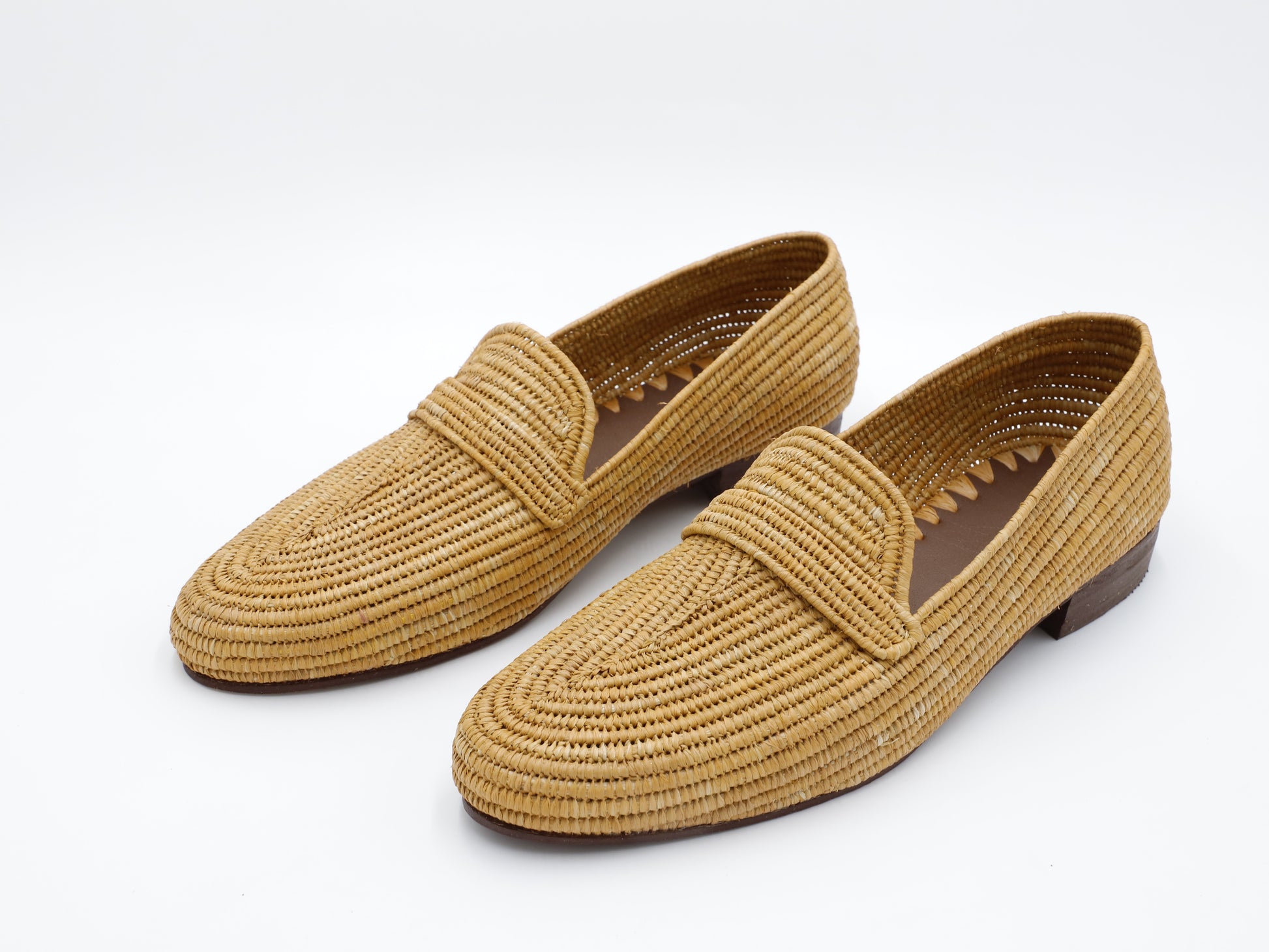 Tan men’s raffia loafers on white background