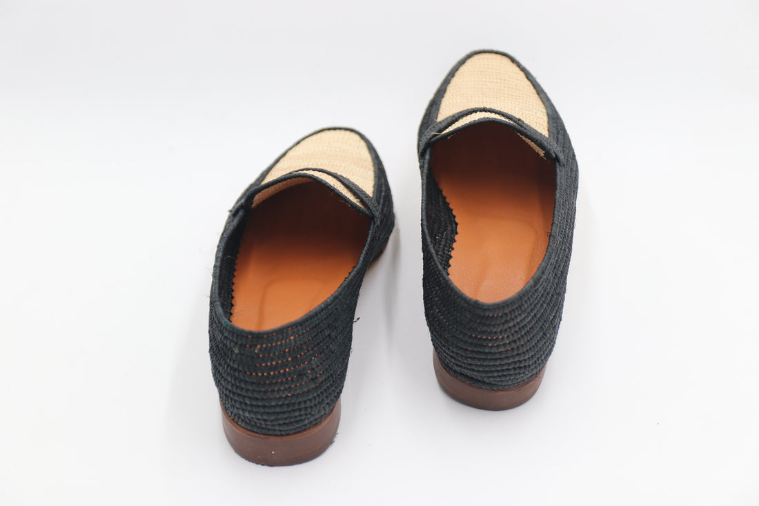 Pair of black woven shoes on a white background