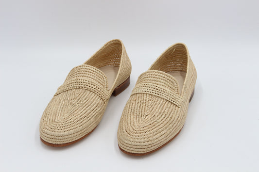 Luxury premium raffia shoes for men displayed on marble surface