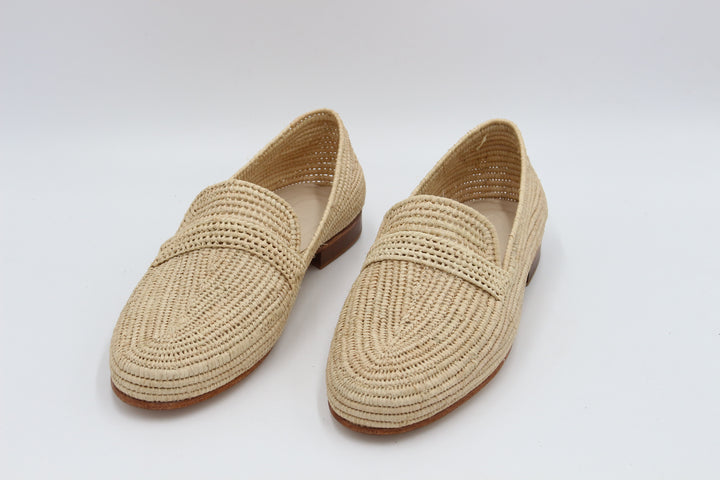 Luxury premium raffia shoes for men displayed on marble surface